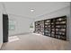Spacious bonus room features wall-to-wall bookcases with carpeted floors and an abundance of natural light at 2050 Poplar Ridge Pl, Cumming, GA 30040