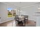 Dining area features hardwood floors, a window with a view, and a chandelier that accents the space at 2050 Poplar Ridge Pl, Cumming, GA 30040