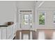Bright entryway with hardwood floors, white trim, and a view of the front door at 2050 Poplar Ridge Pl, Cumming, GA 30040