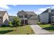 Charming two-story home with stone accents, well-manicured lawn, and an attached two-car garage at 2050 Poplar Ridge Pl, Cumming, GA 30040