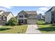 Charming two-story home with stone accents, well-manicured lawn, and an attached two-car garage at 2050 Poplar Ridge Pl, Cumming, GA 30040