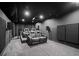 Luxurious home theater with plush seating, projector, and surround sound system for entertainment at 2050 Poplar Ridge Pl, Cumming, GA 30040