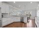 Bright kitchen featuring stainless steel appliances, granite countertops, and peninsula seating at 2050 Poplar Ridge Pl, Cumming, GA 30040
