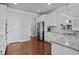 Kitchen showcases granite counters, stainless steel appliances, white cabinets, and hardwood floors in the space at 2050 Poplar Ridge Pl, Cumming, GA 30040