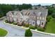 Aerial view of townhomes with manicured lawns and streets, creating an appealing and community-focused neighborhood setting at 2367 Millhaven Se St, Smyrna, GA 30080