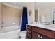 Bathroom with bathtub-shower combo featuring a dark blue shower curtain, vanity with white countertop, and dark cabinets at 2367 Millhaven Se St, Smyrna, GA 30080