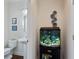 Small bathroom features a pedestal sink, a toilet and a decorative fish tank at 2367 Millhaven Se St, Smyrna, GA 30080