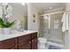 Bathroom featuring a glass-enclosed shower, a toilet, and a vanity with a white countertop and dark wood cabinets at 2367 Millhaven Se St, Smyrna, GA 30080