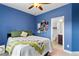 Bedroom with an en-suite bathroom, with a window and a ceiling fan creating a comfortable living space at 2367 Millhaven Se St, Smyrna, GA 30080
