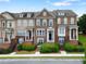 Charming townhome exterior featuring brick accents, manicured landscaping, and inviting entrances at 2367 Millhaven Se St, Smyrna, GA 30080