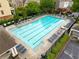 Large community swimming pool with deck chairs and tables for resident enjoyment at 2367 Millhaven Se St, Smyrna, GA 30080