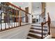 Elegant staircase with wood and wrought iron banister leading to the living area at 2367 Millhaven Se St, Smyrna, GA 30080
