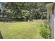 Large backyard with a fire pit, storage shed, and a wooden fence offering privacy at 3135 Bluebird Ln, Decatur, GA 30032