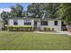 Charming one-story home featuring a white exterior, well-manicured lawn, and inviting curb appeal at 3135 Bluebird Ln, Decatur, GA 30032