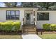 Attractive home with a tidy front yard and a welcoming entrance with stairs leading to the front door at 3135 Bluebird Ln, Decatur, GA 30032