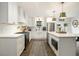 Stylish kitchen with white cabinets, stainless steel appliances, and a large center island with pendant lighting at 3135 Bluebird Ln, Decatur, GA 30032