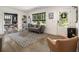 Bright living room with large windows, grey sofa, and modern decor with direct view to the Dining Room at 3135 Bluebird Ln, Decatur, GA 30032