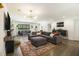 Spacious open living area with a grey sofa, modern lighting, and seamless connectivity to other living spaces at 3135 Bluebird Ln, Decatur, GA 30032