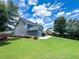 Expansive backyard featuring a lush lawn, mature trees, and a covered patio, perfect for outdoor living at 3804 Bay Orchard Lane, Loganville, GA 30052