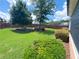 Large backyard featuring mature trees, landscaping, manicured shrubs, a stained fence and green lawn at 3804 Bay Orchard Lane, Loganville, GA 30052