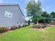 Well-maintained backyard with manicured lawn, flowering shrubs, mature trees and storage shed at 3804 Bay Orchard Lane, Loganville, GA 30052