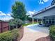 Inviting covered patio featuring brick pathway, ceiling fans, outdoor furniture and a scenic backyard view at 3804 Bay Orchard Lane, Loganville, GA 30052