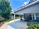 Relaxing covered patio with outdoor furniture, ceiling fans, and view of the beautifully landscaped backyard at 3804 Bay Orchard Lane, Loganville, GA 30052