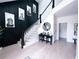 Elegant foyer featuring a staircase, stylish decor, and light wood floors at 3804 Bay Orchard Lane, Loganville, GA 30052