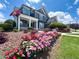 Inviting home with a landscaped yard featuring vibrant flowers and a welcoming porch at 3804 Bay Orchard Lane, Loganville, GA 30052