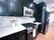 Modern kitchen with stainless steel appliances, black cabinetry, and white marble backsplash at 3804 Bay Orchard Lane, Loganville, GA 30052