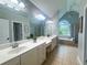 Bright main bathroom with double vanity, garden tub, and tiled flooring at 3804 Bay Orchard Lane, Loganville, GA 30052