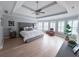 Inviting main bedroom with tray ceiling, light-filled windows, and light wood flooring at 3804 Bay Orchard Lane, Loganville, GA 30052