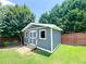 Well-maintained storage shed with double doors and ramp nestled in the lush, green backyard at 3804 Bay Orchard Lane, Loganville, GA 30052