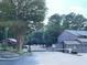 Gated community entrance with mature trees and a guard house at 3828 Woodridge Way, Tucker, GA 30084