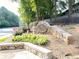 Welcome to Woodridge community sign, featuring stone masonry and lush landscaping at 3828 Woodridge Way, Tucker, GA 30084