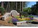 Community sign with landscaping featuring colorful flowers and stone construction at 3828 Woodridge Way, Tucker, GA 30084