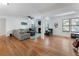 Open-concept living room with hardwood floors, a gray couch, and modern furnishings at 3828 Woodridge Way, Tucker, GA 30084
