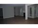 Living room featuring hardwood floors, white trim, and a fireplace with a dark hearth at 3828 Woodridge Way, Tucker, GA 30084