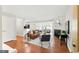 Open-concept living room with hardwood floors, fireplace, and ample natural light at 3828 Woodridge Way, Tucker, GA 30084