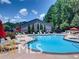 Community pool with lounge chairs and umbrellas for residents to relax and enjoy the outdoors at 3828 Woodridge Way, Tucker, GA 30084