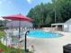 Community pool with lounge chairs and umbrellas, providing residents a relaxing outdoor space at 3828 Woodridge Way, Tucker, GA 30084