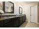 Bathroom features double sinks, dark wood cabinets, granite counters, and neutral tile floor at 132 Cornerstone Pl, Woodstock, GA 30188