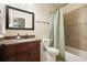 Clean bathroom with dark cabinets, granite countertop, shower, and tub at 132 Cornerstone Pl, Woodstock, GA 30188