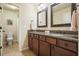 Double vanity bathroom with granite countertop, modern fixtures, and tiled floors at 132 Cornerstone Pl, Woodstock, GA 30188