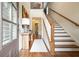 Welcoming foyer with hardwood floors, staircase, and stylish console table under painting at 132 Cornerstone Pl, Woodstock, GA 30188