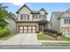 Charming two-story home featuring a stone-accented front, landscaped yard, and a two-car garage at 132 Cornerstone Pl, Woodstock, GA 30188