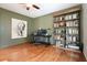 Inviting home office with hardwood floors, built-in bookshelves, and a comfortable workspace at 132 Cornerstone Pl, Woodstock, GA 30188