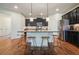 Bright kitchen featuring a center island with seating, stainless steel appliances, and dark cabinetry at 132 Cornerstone Pl, Woodstock, GA 30188