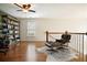 Upstairs living room with hardwood flooring, bookshelves, and comfortable seating area at 132 Cornerstone Pl, Woodstock, GA 30188