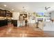 Open concept living room showcasing a modern kitchen, fireplace, and hardwood floors at 132 Cornerstone Pl, Woodstock, GA 30188
